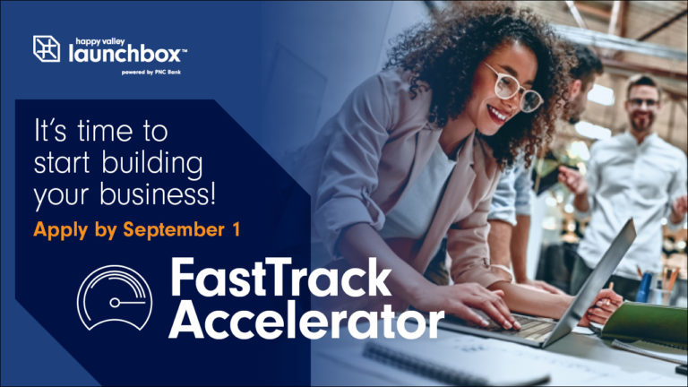 FastTrack Accelerator logo overlaid on an image of a woman working on a computer