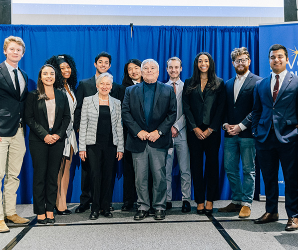 Student founders stand onstage with President Barron