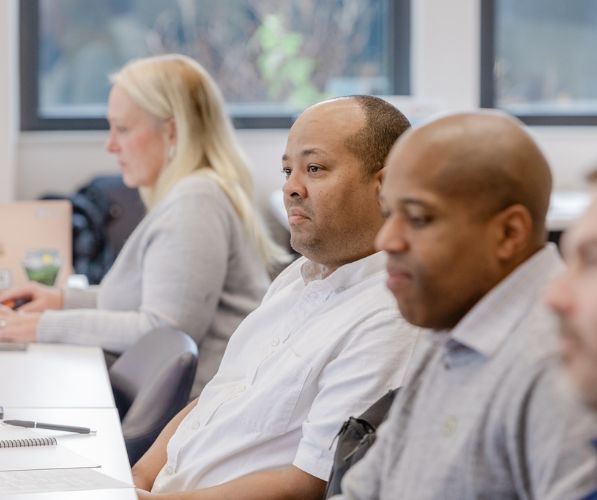 Participants sitting at a table during the Boots to Business Reboot