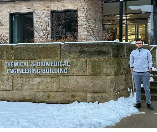 Ali stands in front of the Penn State Chemical & Biomedical Engineering Building